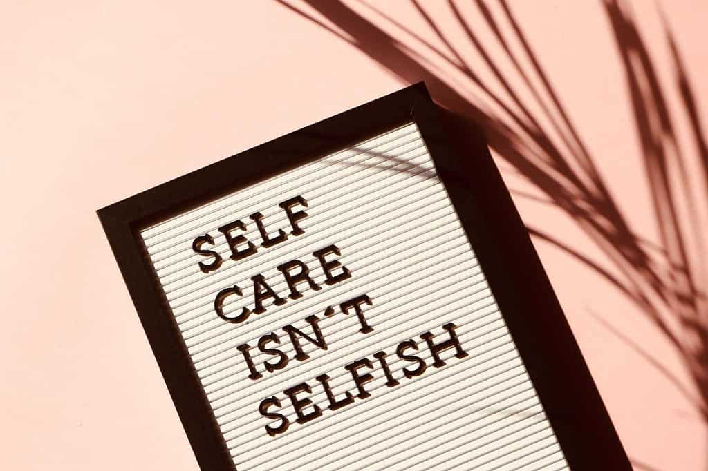 A poster board with the text "self care isn't selfish"