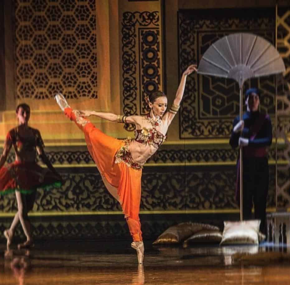 Emily-Joy Smith (ballerina) dancing in an orange costume for the Moravske Divadlo Olomouc