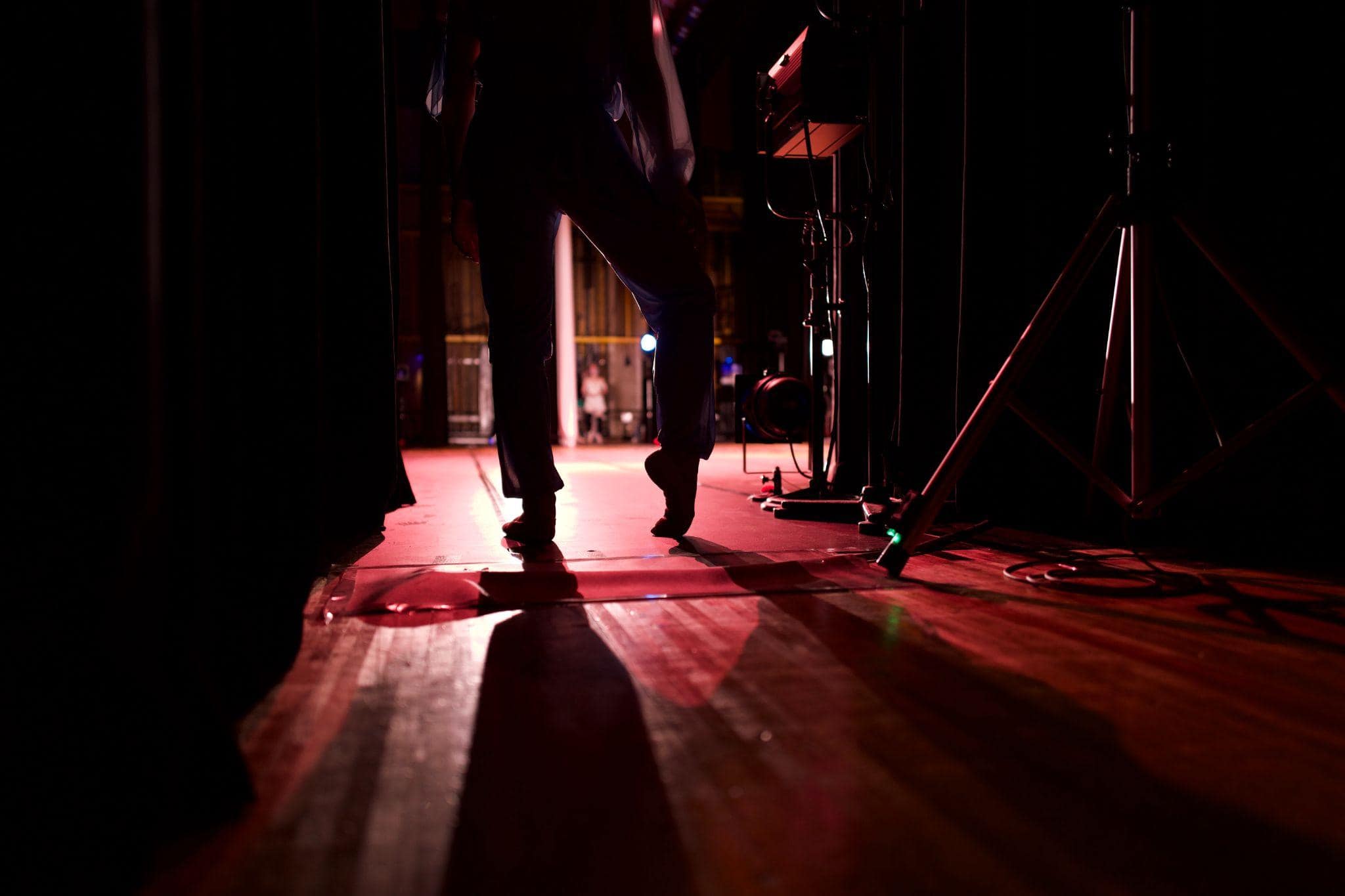 A dancer on the side of the stage with feet pointed