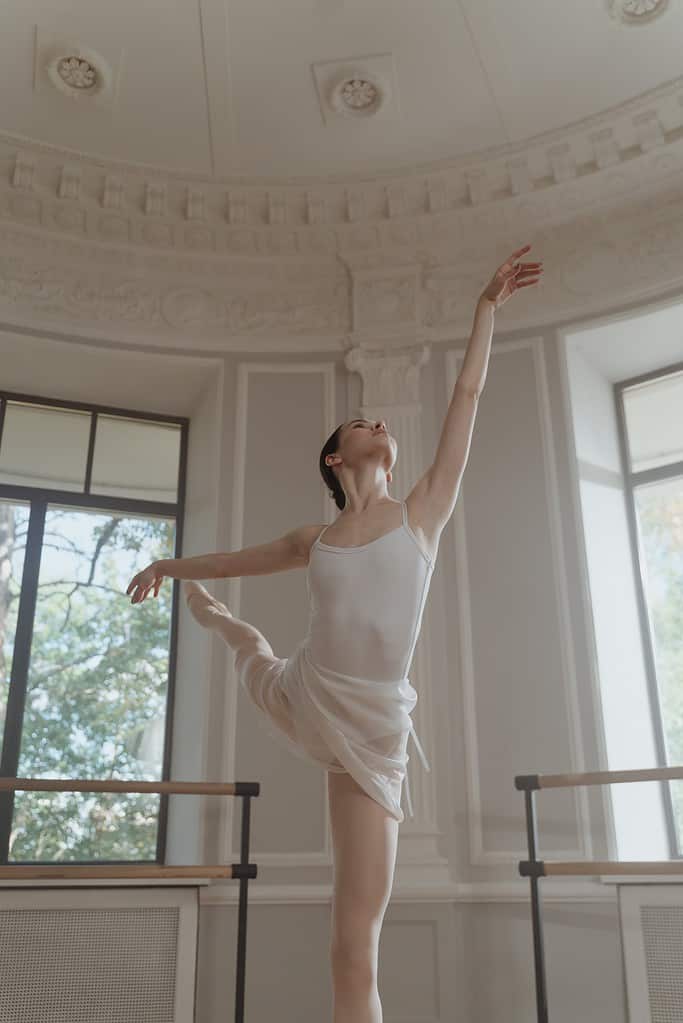 Female ballerina in an arabesque position to improve flexibility