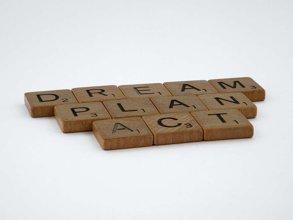 Scrabble tiles identifying the words "dream, plan, act"