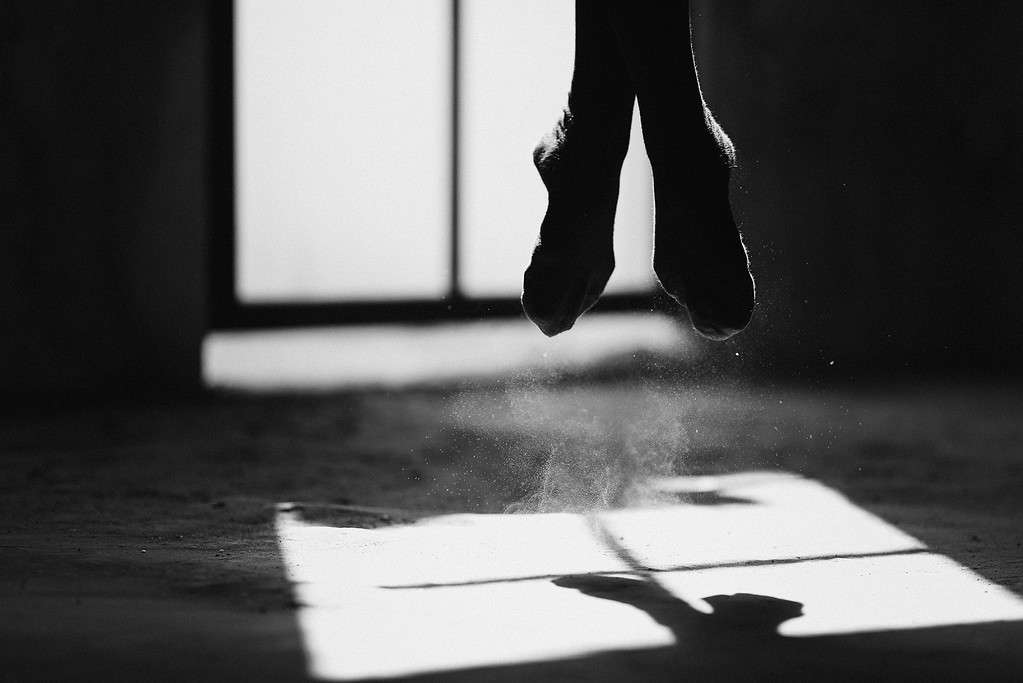 Female dancer jumping in her home dance studio