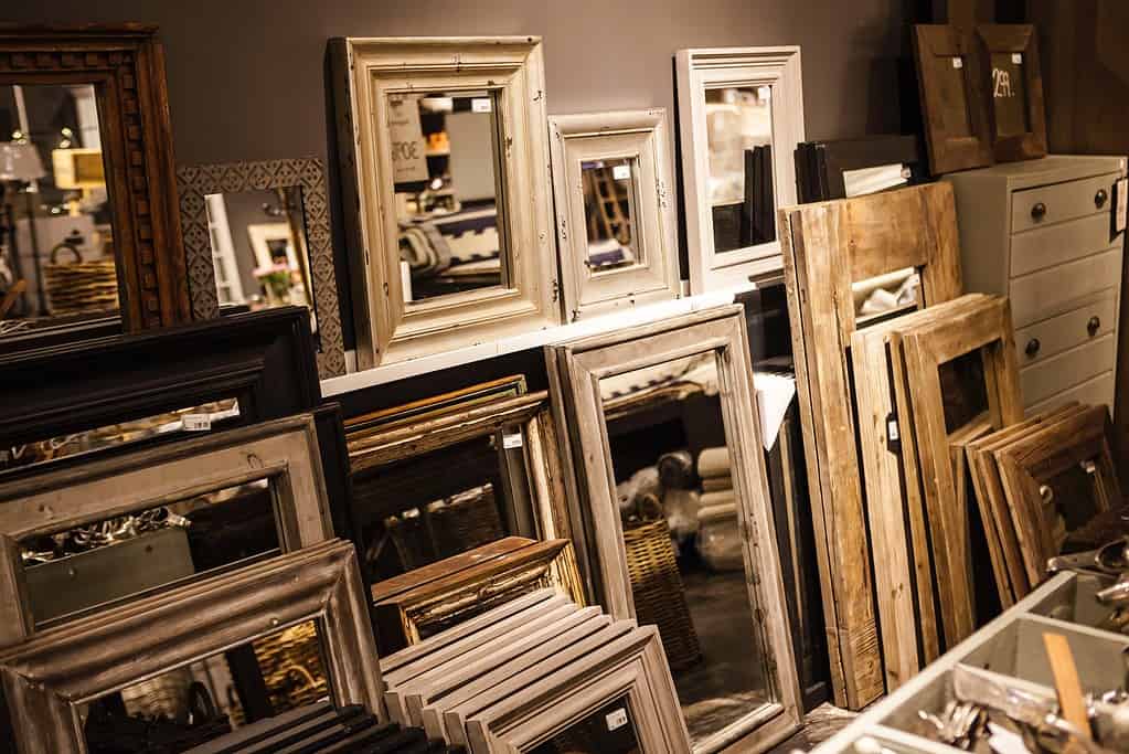 A wall of different size and shaped mirrors for a potential home dance studio addition