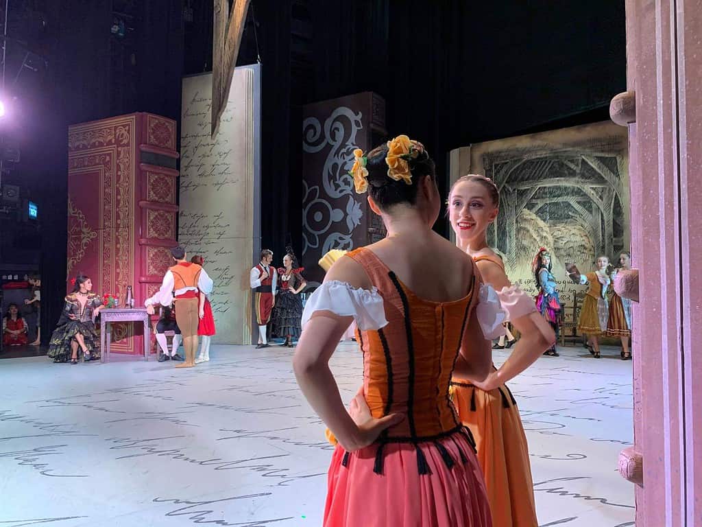 two professional ballerinas on stage during a performance