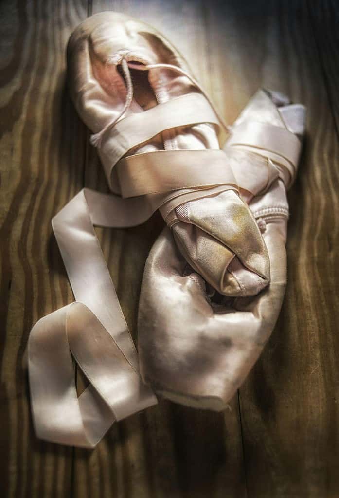 pointe shoes on wooden floor