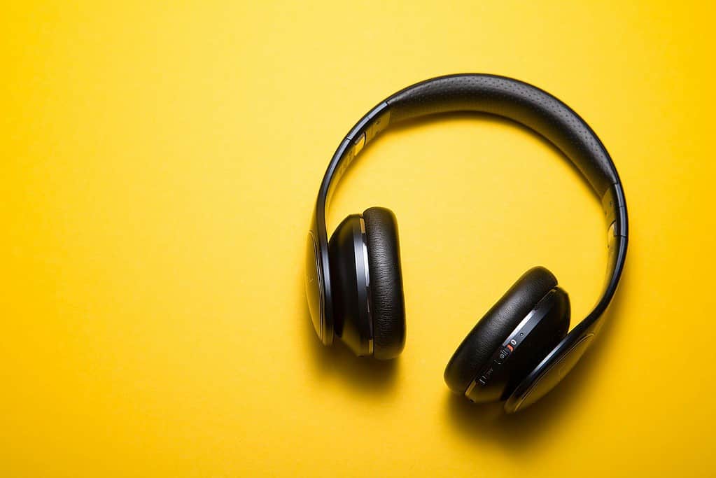 black headphones against yellow background