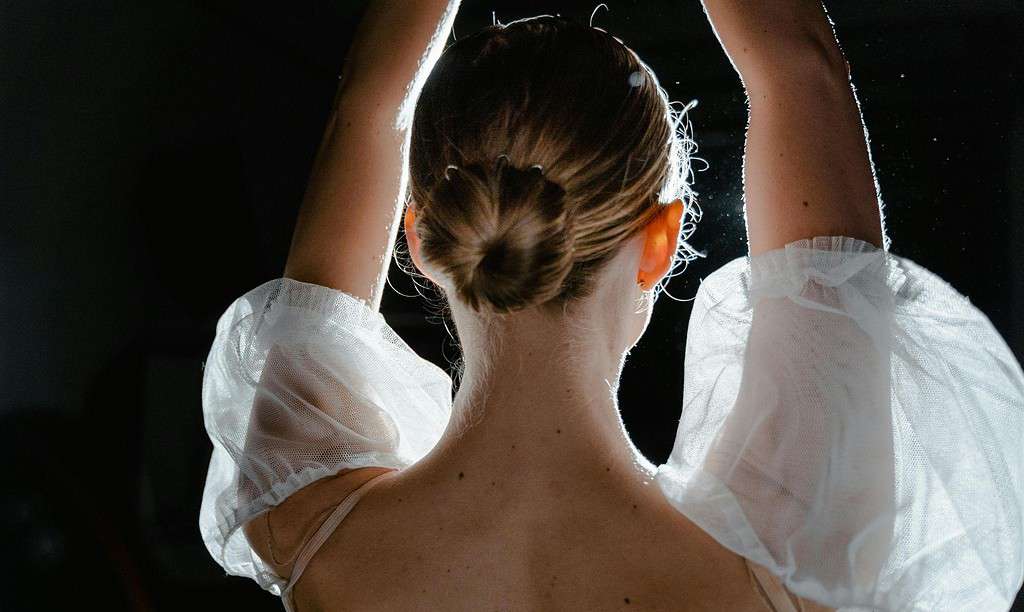 Female dancing showcasing a simple ballet bun