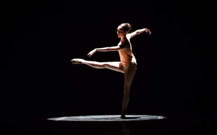 Soloist dancer on stage with french roll ballet bun