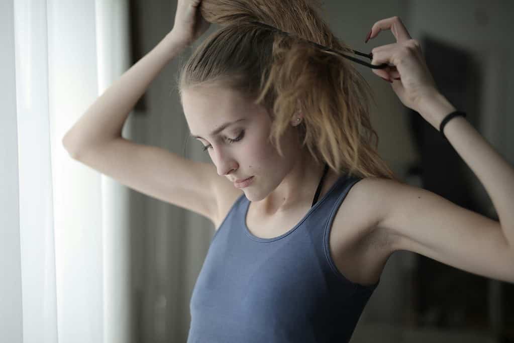 Hair being prepared in a pony tail