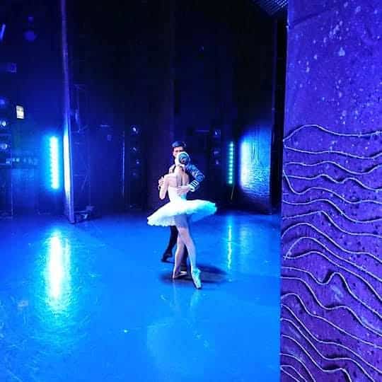 Odette and Prince Siegfried at the lake during swan lake ballet performance