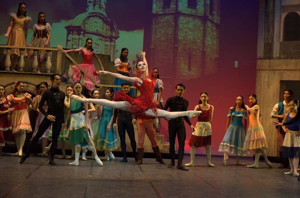 Abigail Oliveiro on stage in a red costume