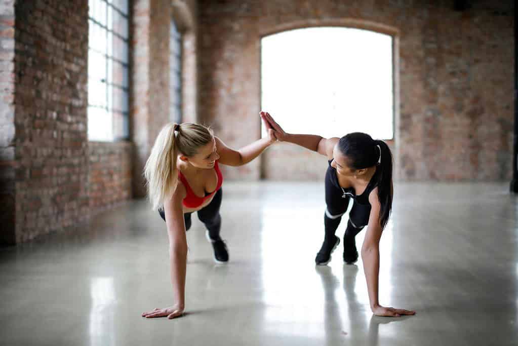 Two dancers performing a ballet warm up together