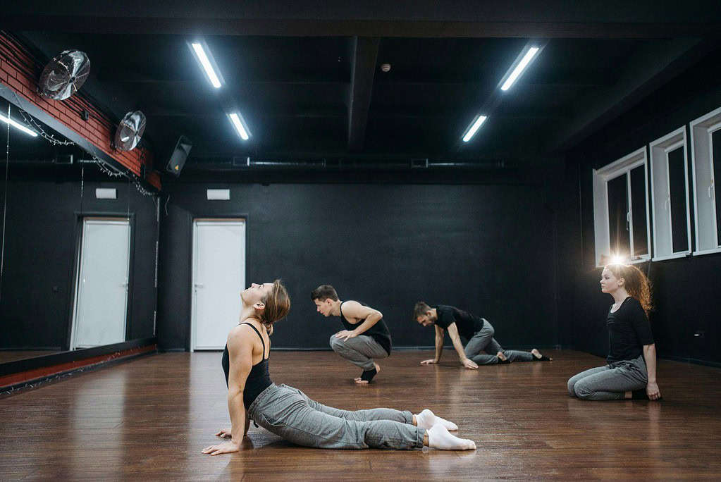 Dancers performing a ballet warm up in a studio