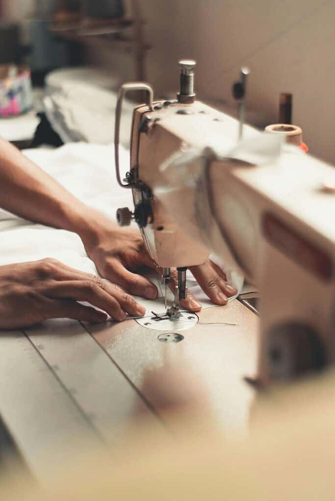 Lady sewing a costume using sewing machine