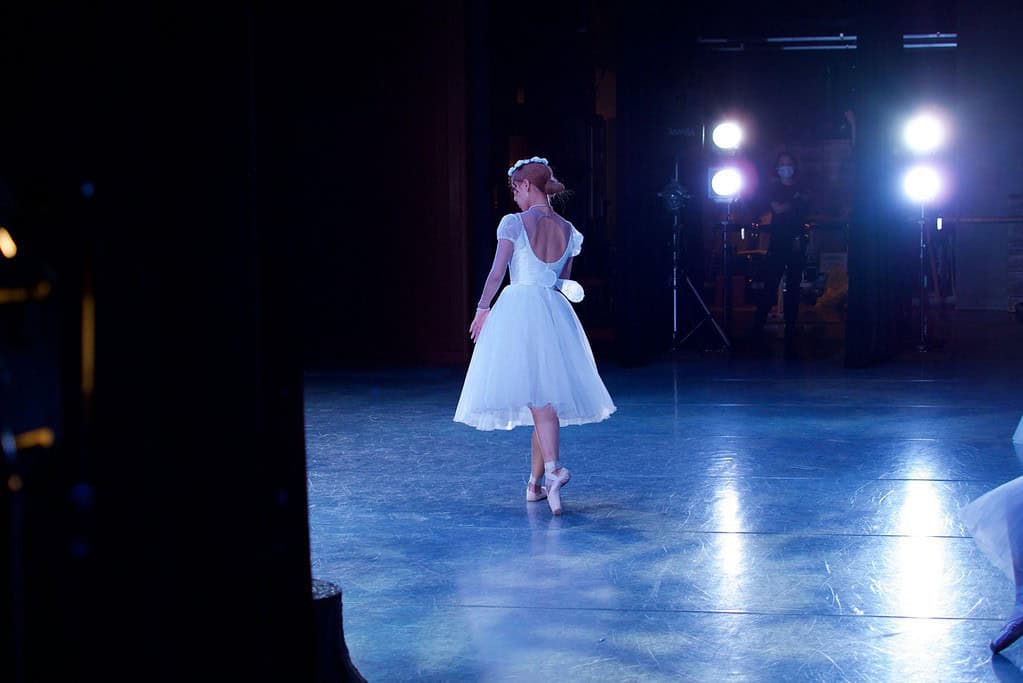 Ballet dancer on stage acting as principal dancer within ballet company hierarchy