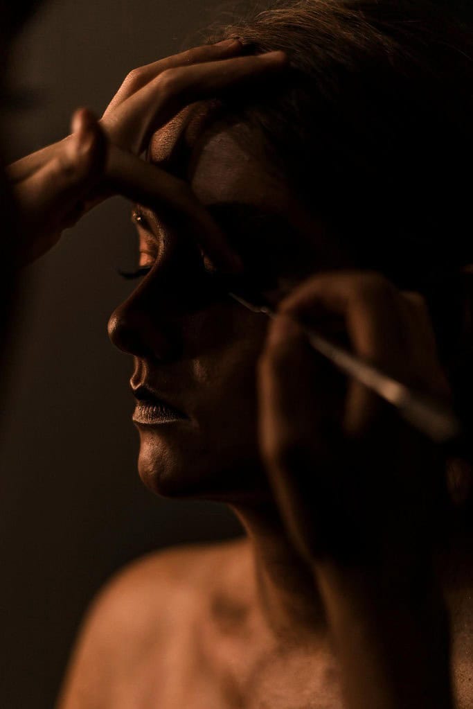 Applying face makeup before a ballet performance