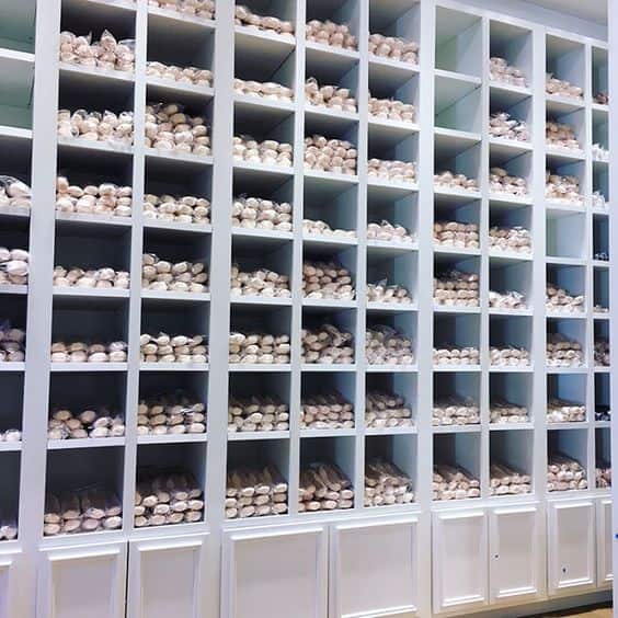 Hundreds of new pointe shoes stacked in a store