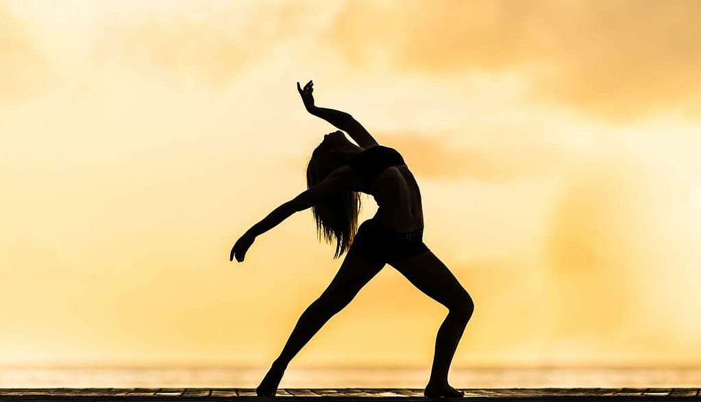 Dancer feeling recharged against a orange/yellow backdrop