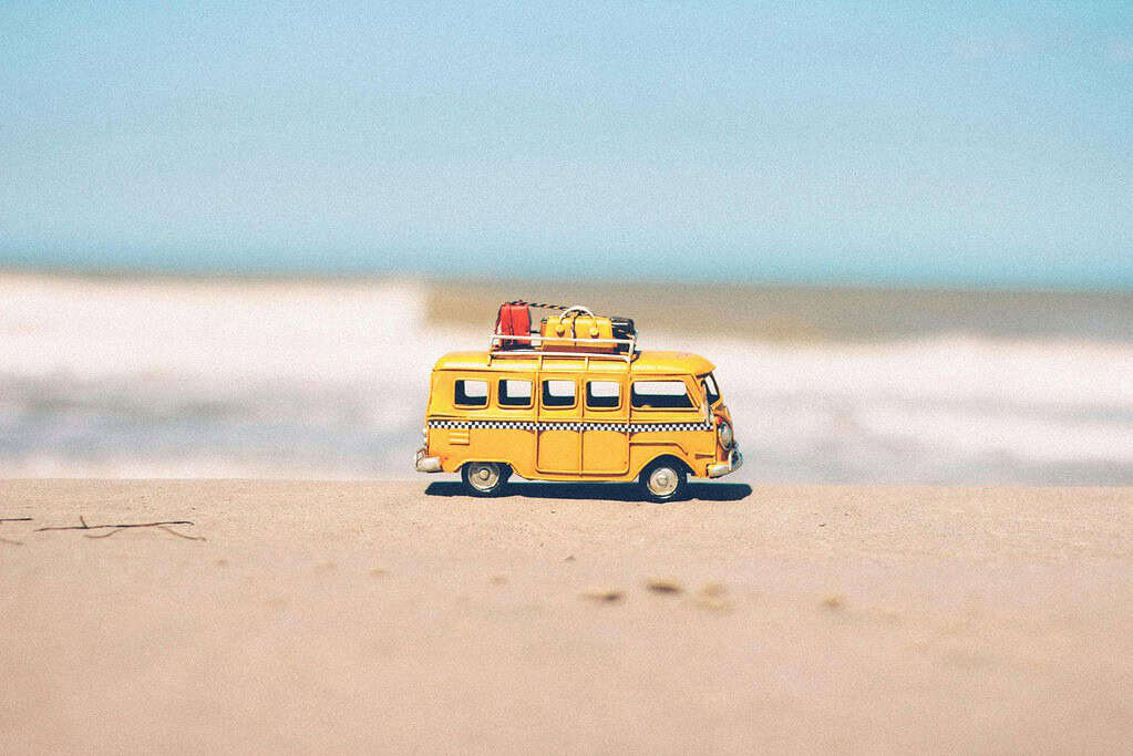 Yellow convey van on holidays at the beach