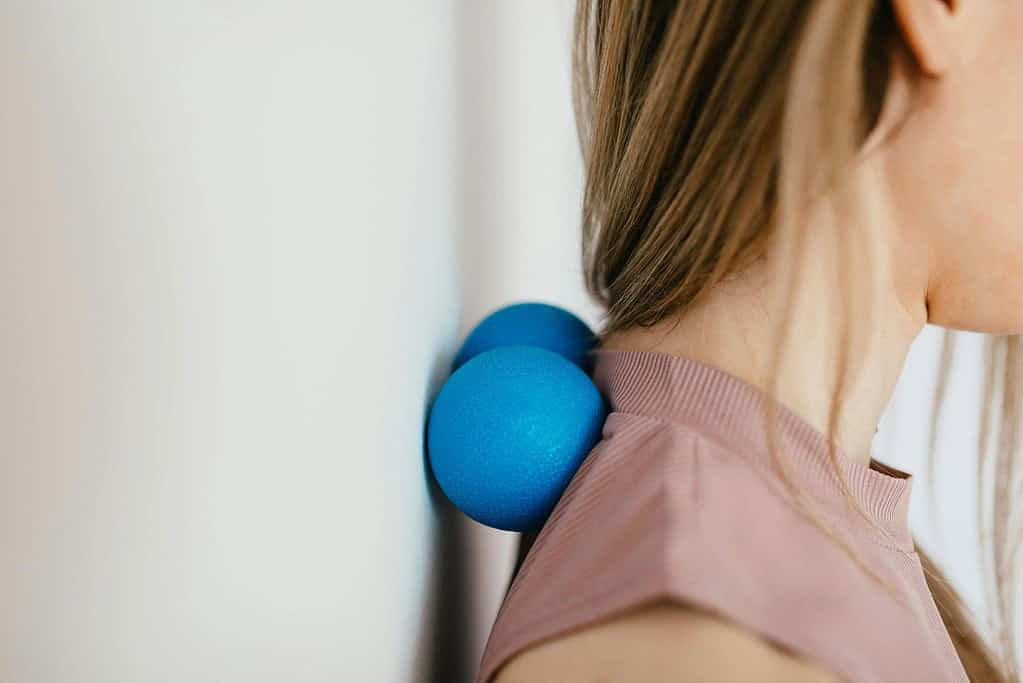 Massaging the neck and upper back with peanut massage ball