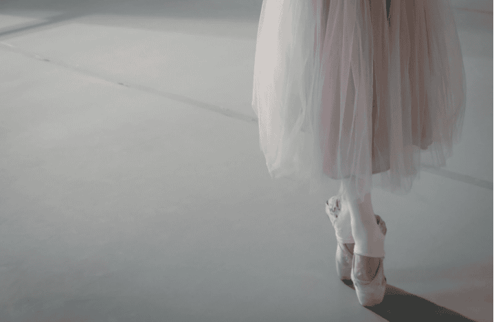 Ballerina on her toes in pink tutu skirt