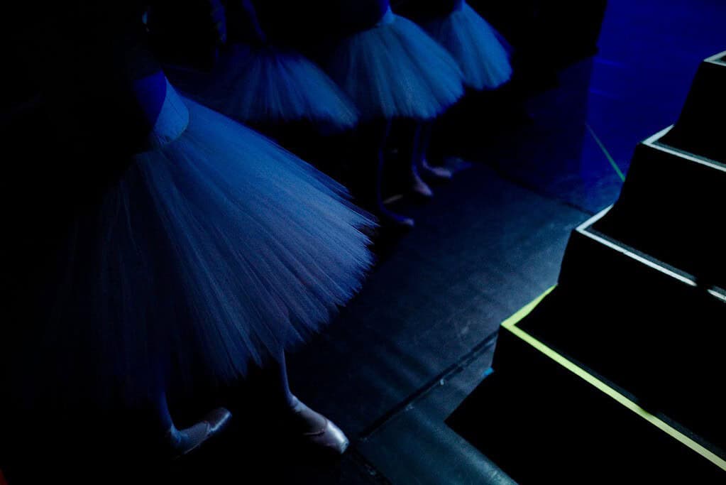 Dancers standing in the wings backstage