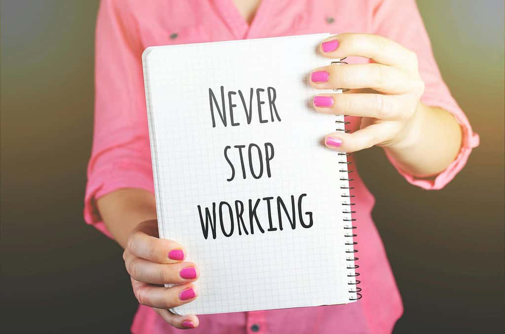 Lady holding up a never stop working sign