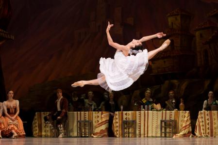 Natalia Osipova doing a high ballet jump on stage