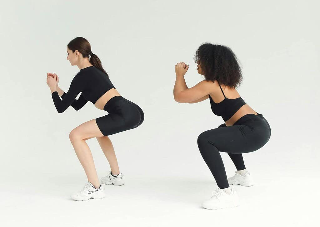 Two women performing body weighted squats