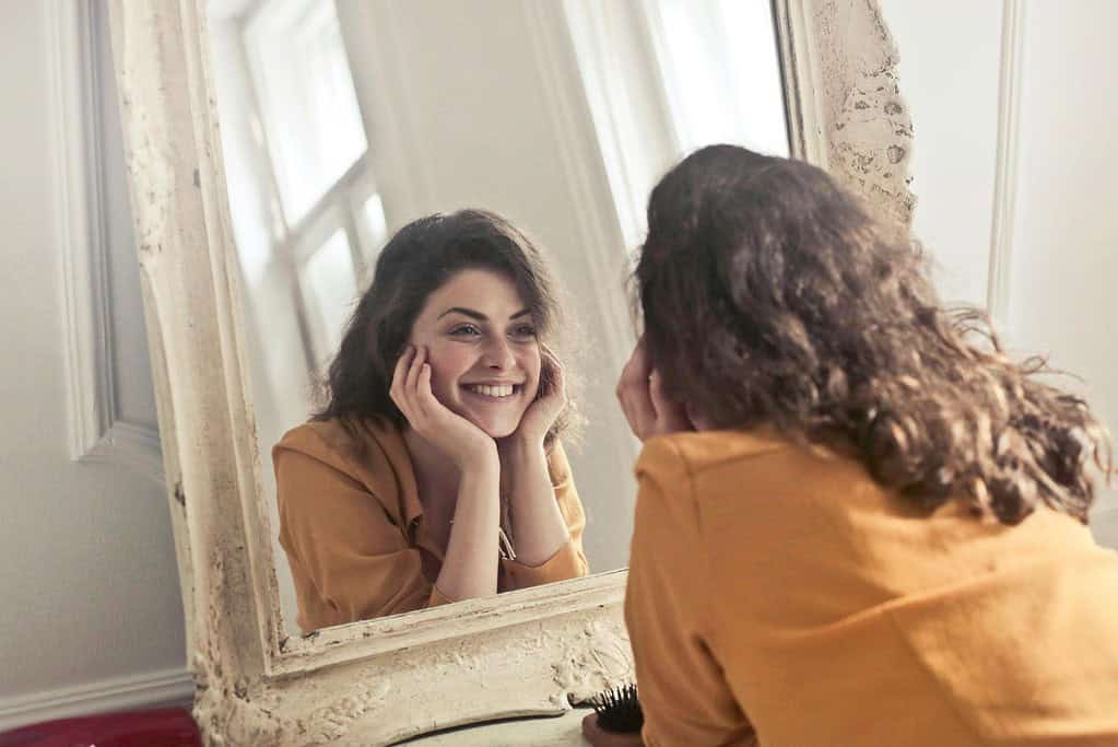 Practising morning affirmations in front of a mirror