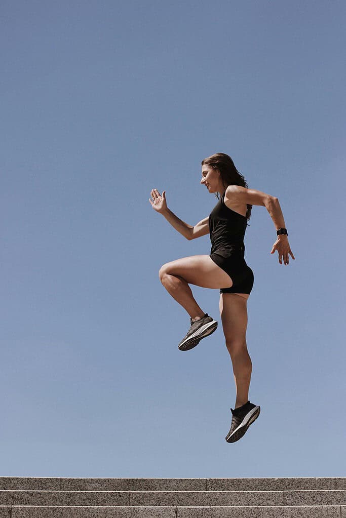 Women performing plyometric training outside