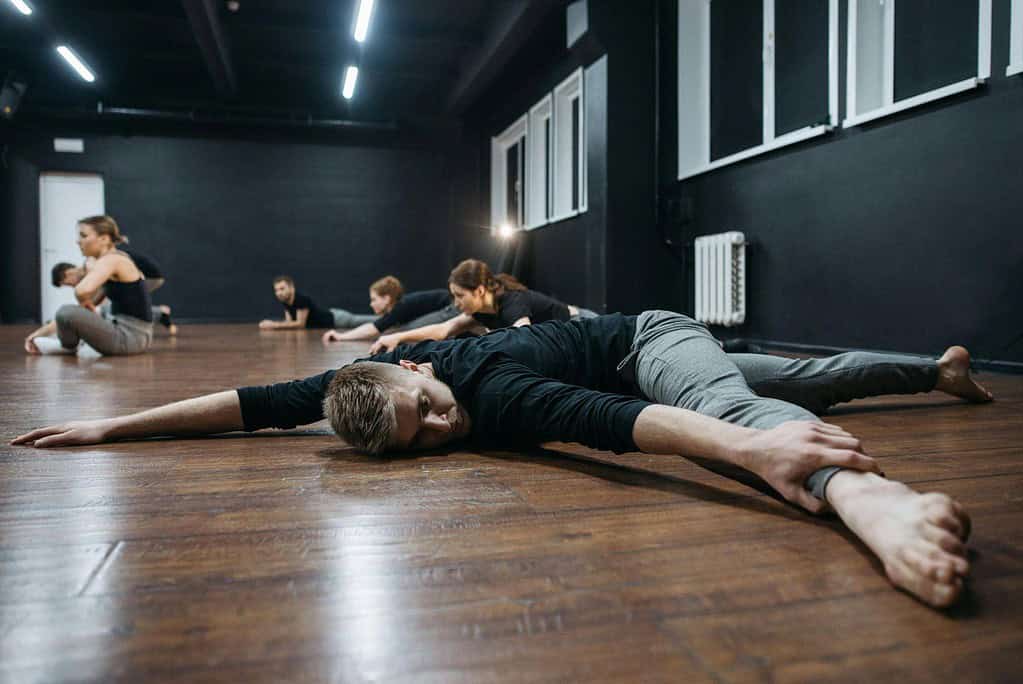 Male dancer performing ballet floor barre routine