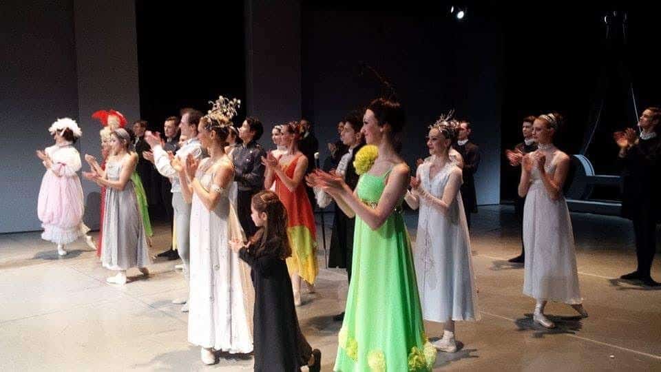 Dancers applauding each other on stage